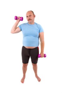 Top 10 Ways to "UN" Motivate Your Clients 1 Demotivated Sports Man With Dumbbells And A Too Tight Shirt