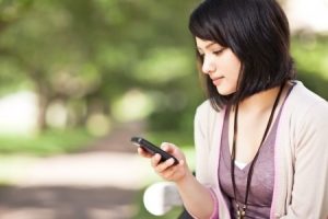 girl texting on the phone at campus