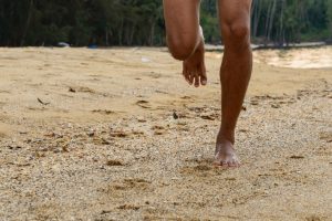 Barefoot Running On Beach At Sunset.
