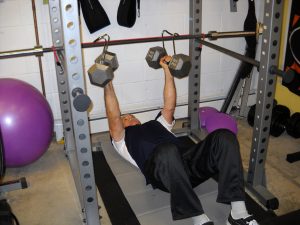 How to do a Floor Dumbbell Chest Press with Power Hooks