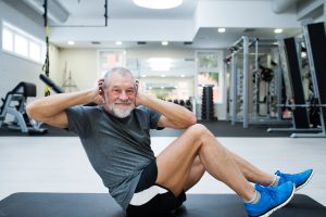 Fit,Senior,Man,In,Gym,Working,His,Abs,,Doing,Crunches.