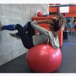 girl supine on stability ball