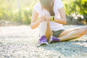 Runner Sport Knee Injury. Woman In Pain While Running In Park