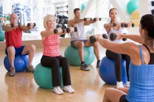 Instructor Taking Exercise Class At Gym