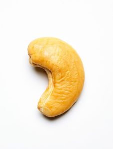 One Cashew Nut Close Up Isolated On A White
