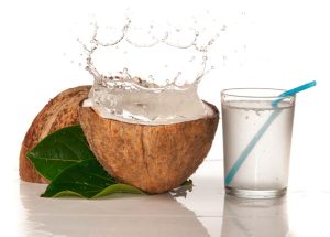 Coconut With Water Splash Over White