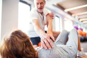 Senior Physiotherapist Working With A Female Patient.