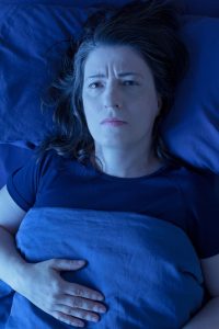 Woman Awake Bed Night Insomnia, restless leg syndrome, or fear